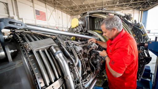 Man working on an open plane engine