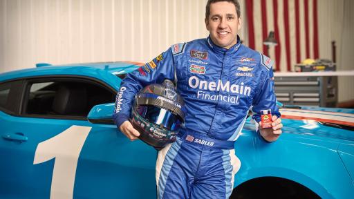 NASCAR Driver Elliott Sadler standing by his blue race car