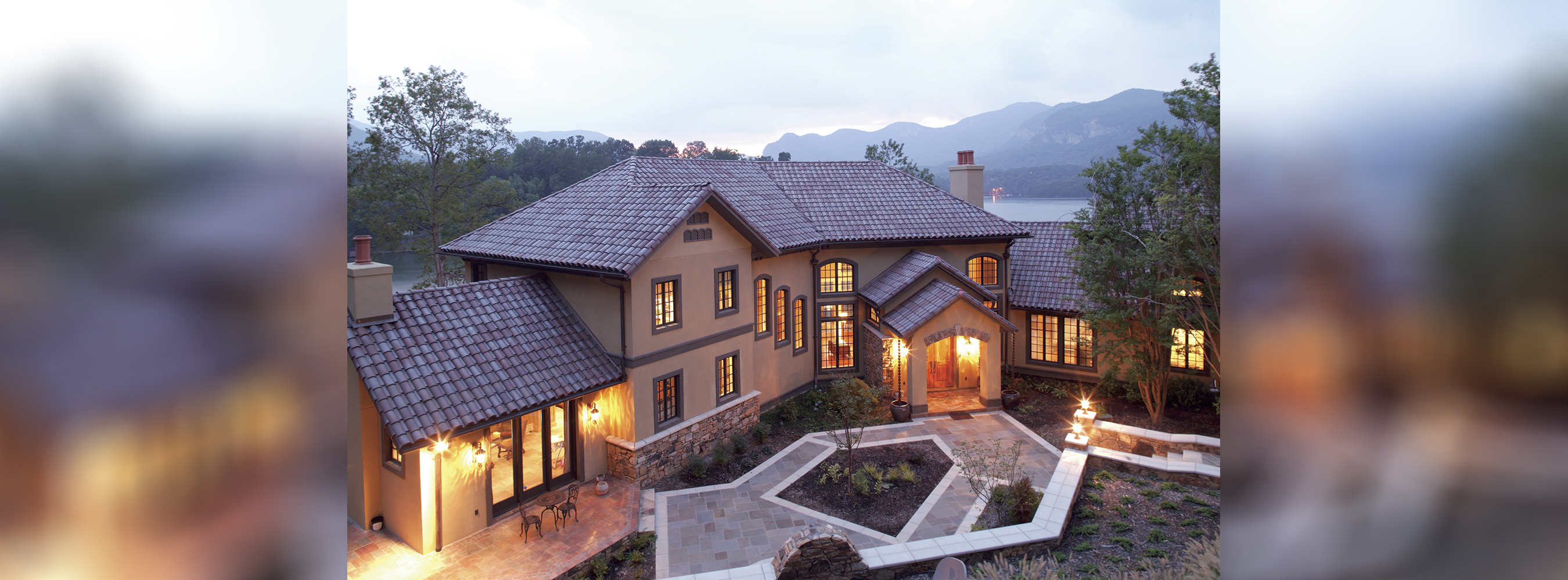 Banner image of a large house on the lake