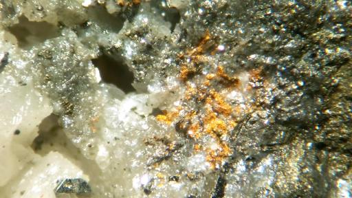 Closer up of gray rock with orange spot