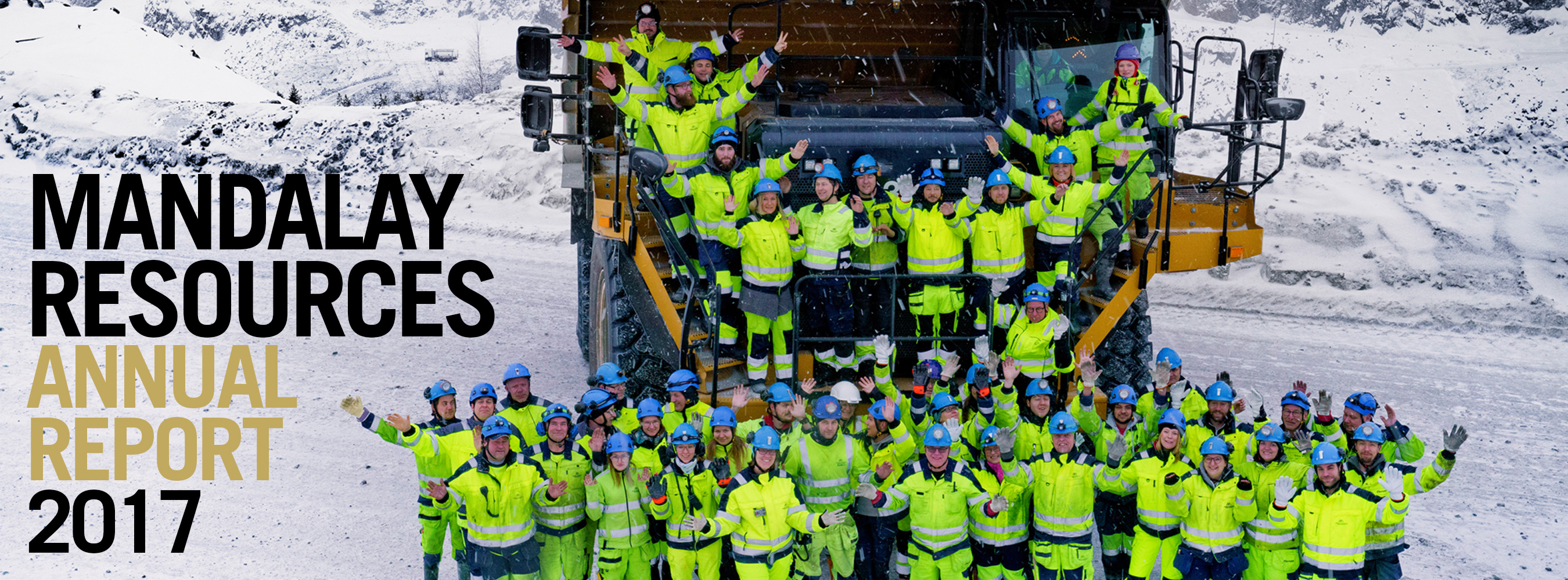 Banner image of a large group of workers standing on and around a large truck