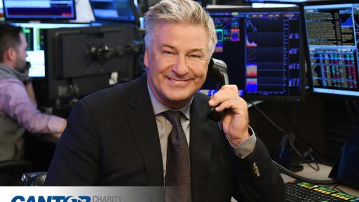 Alec Baldwin on the phone smiling into the camera.
