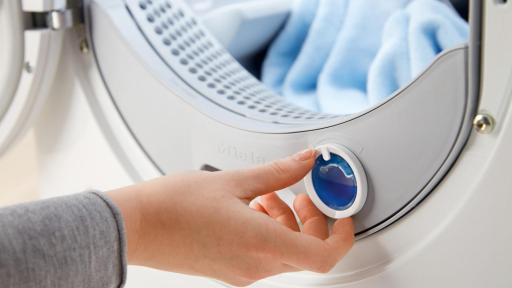 A dial on the inside of the washing machine door that is being adjusted for fragrance.