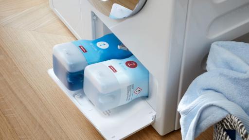 The bottom of a W1 series washing machines with the detergent solution system inserted into the machine.