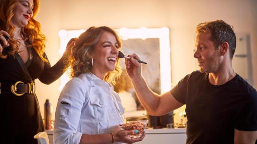 Victoria Arlen in a making chair holding a bow of almonds
