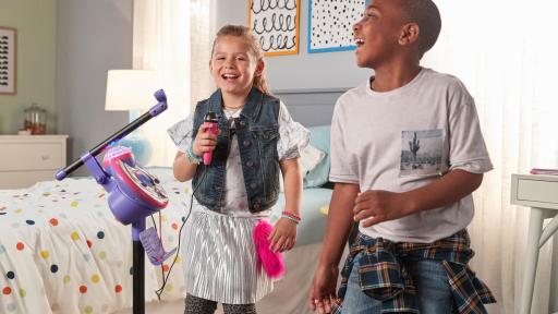 Boy and girl singing into the Kidi Star Karaoke Machine mic