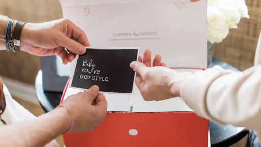 Two people opening a box.