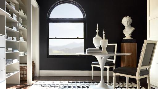 Casement window in a room with walls painted black