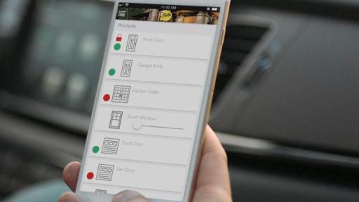 Person holding iPhone displaying Pella Insynctive App interface