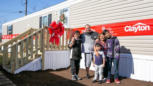 Family photo outside new Clayton home