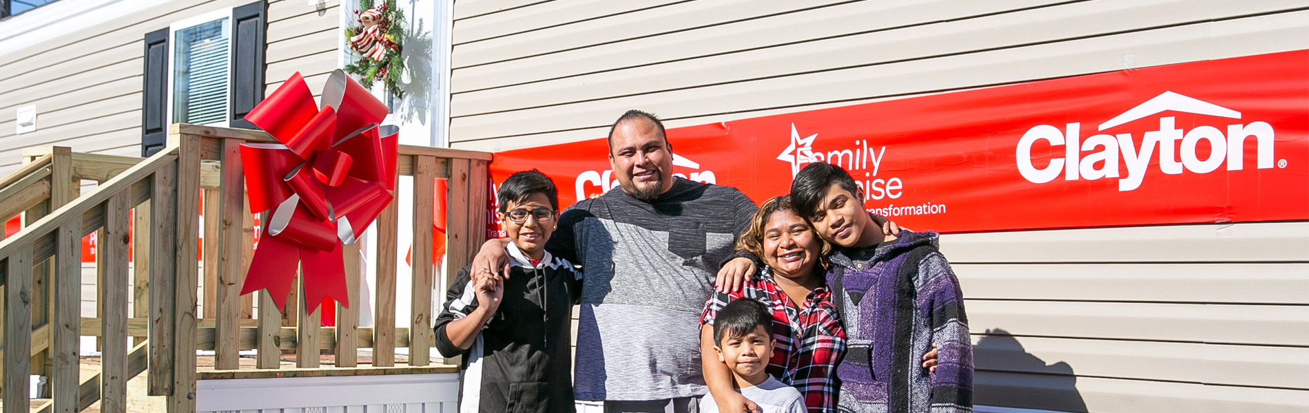 Family photo outside new Clayton home