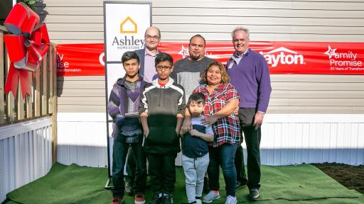 Family photo outside new Clayton home
