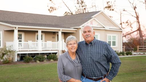 Terry and Darla pose before their home