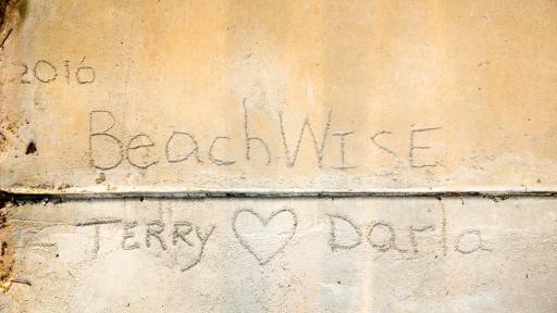 Writing in the sand that says 2016 Beachwise, Terry and Darla