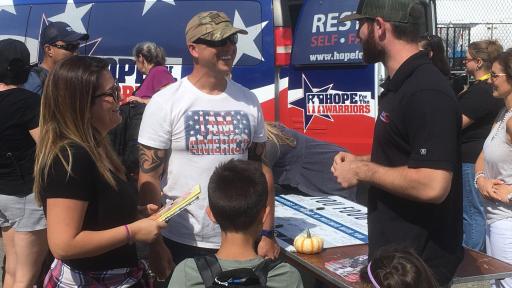 Hope for the Warriors member speaking to a veteran and his family.