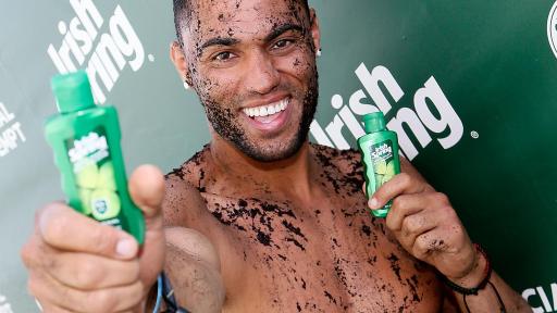 Ryan Klarenbach covered in dirt holding Irish Springs product