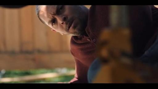 Joe looking under a car.