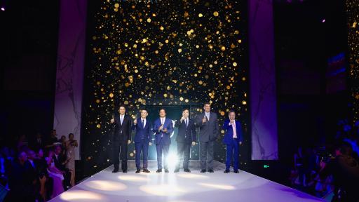 The management of Suning standing on a stage at the Bellagio.
