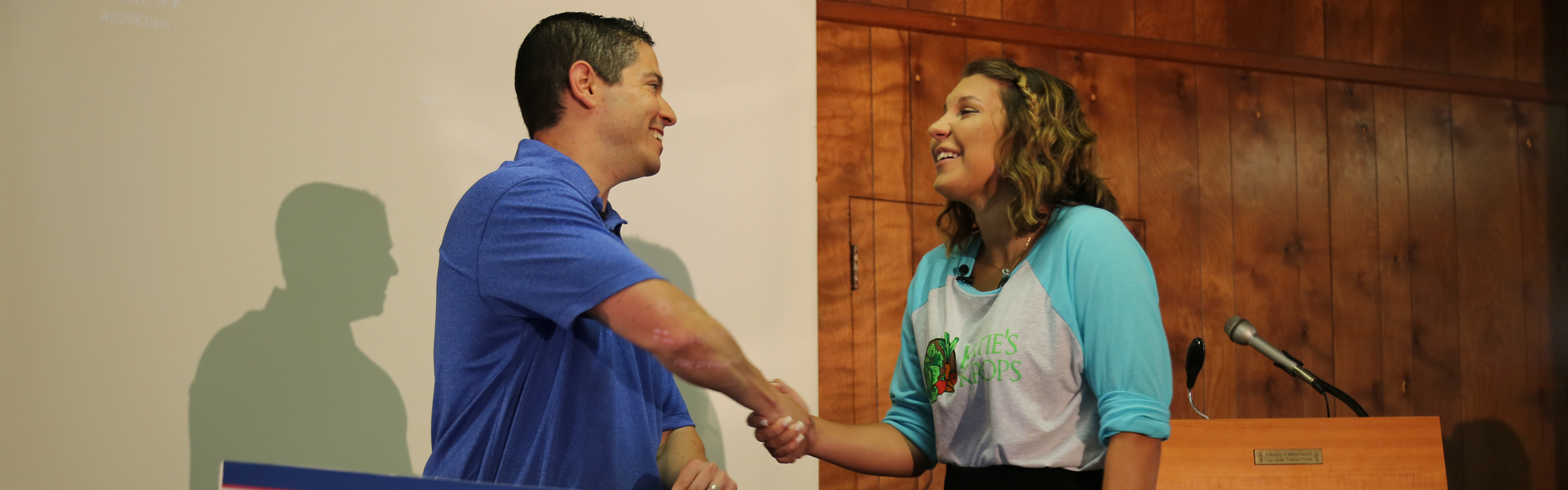 Man presenting a woman with a $50,000 check.