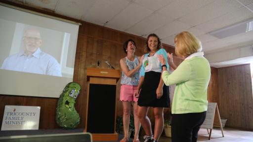 Three women watching something on a projector.