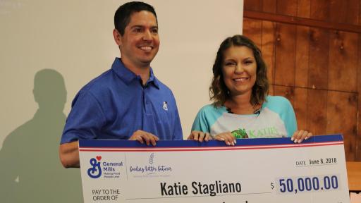 Man and woman holding a check for $50,000.