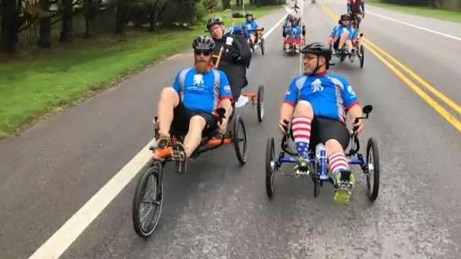 Man pulling around wound warrior on custom made bike