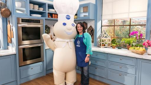Amy Nelson and the Pillsbury Doughboy standing in a beautiful kitchen.