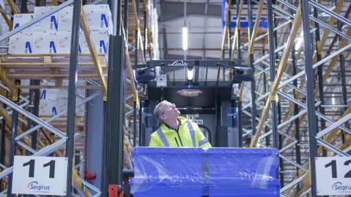 Man storing boxes in Seqirus warehouse in Liverpool vaccine lab