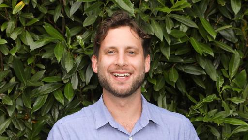 Maxwell Cohen standing against a wall.