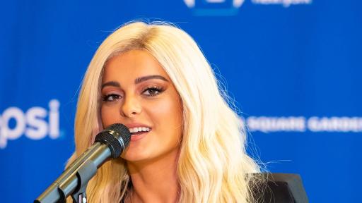 Close-up of Bebe Rexha singing in front of an audience