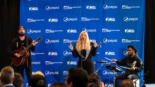 Bebe Rexha singing in front of an audience