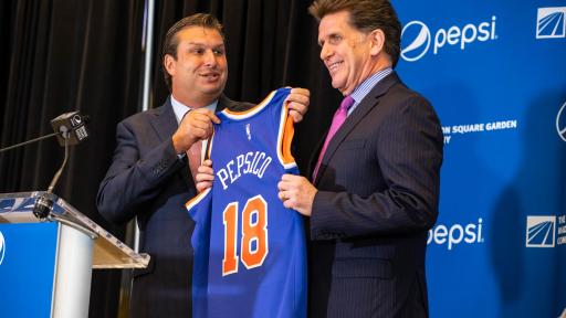 President Andy Lustgarten holding a PepsiCo jersey with PepsiCo North America CEO Al Carey