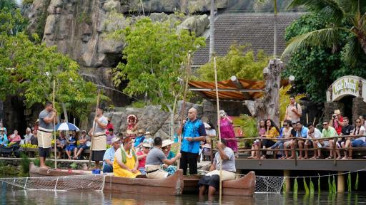 Polynesian  Cultural  Center  President  &  CEO  Alfred  Grace  welcomes crowd  for  the  world  premiere  of  Huki, as  he  is  pulled  into  the  freshwater  lagoon  on  a canoe  via  fishing  net.