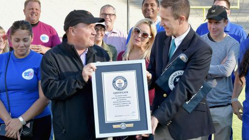 Guy handing award to another guy