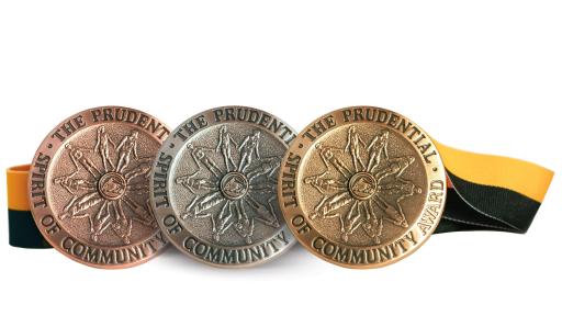 The three medallions, copper silver and gold with the black and gold ribbon behind them.