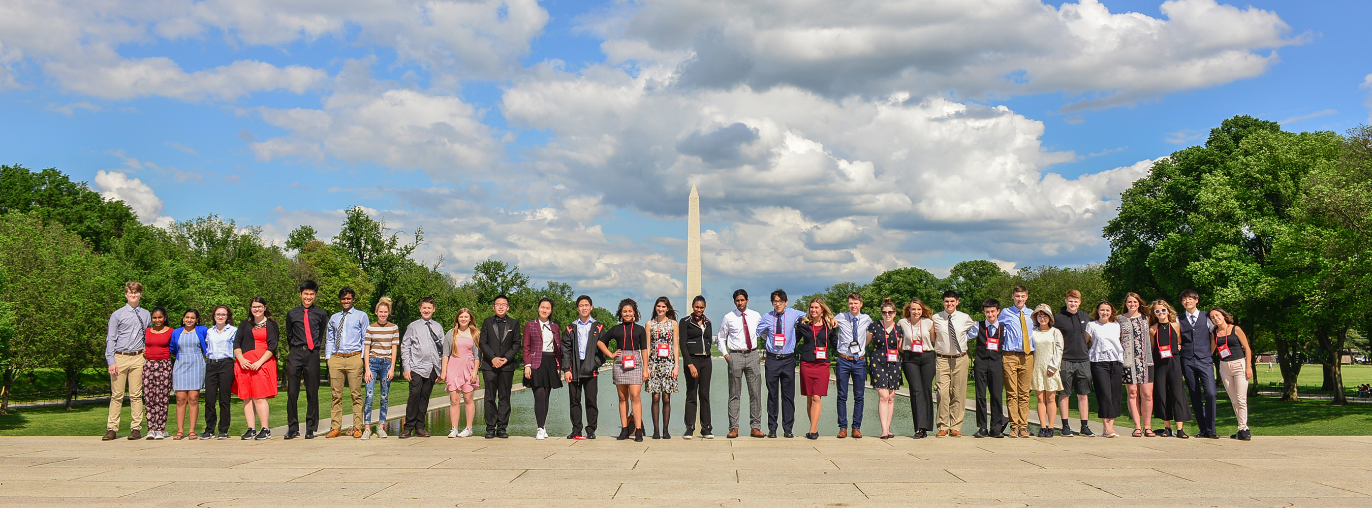 Many youth volunteers standing in a line for a picture in front of the Lincoln Memorial Reflecting Pool