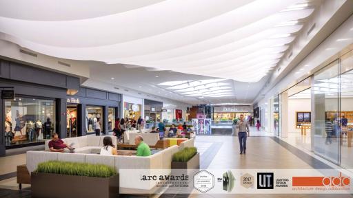 The Cloud project was directed at revitalizing the dark corridor in front of Apple and Abercrombie & Fitch on the 2nd floor of the mall&rsquo;s Dillards Wing. Due to the imbalance of lighting and natural sunlight from the skylights down the wing coming into this space, the intent was to create a light fixture that could provide ample visibility in the area while also incorporating a unique experience for the shoppers as they navigate through the space. Veering away from the rigid orthogonal build-outs throughout the rest of the project, The Cloud took a rather organic approach through a series of 3-form panels, each custom made carefully with slight adjustments, to cascade as shoppers walked from one side to another. Lit by Birchwood Lighting&rsquo;s NOLAN LED linear lights, the translucent 3Form panels provided The Cloud the signature transparency resembling natural clouds in the sky.