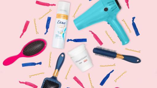 Image of a blowdryer, hairbrushes on a hair ribbons on a pink background.