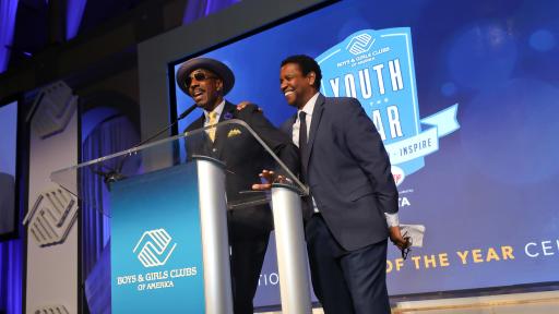 Men giving speech during award ceremony