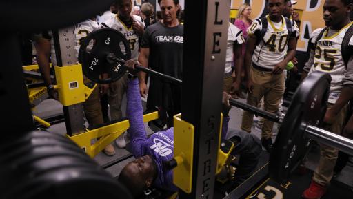 Optimum Nutrition sponsored athletes, Kelechi Opara and Sean Royer, show training technique to Michele Clark students