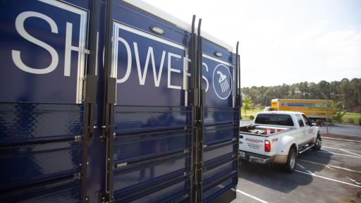Shot of the side of a blue trailer with Showers.