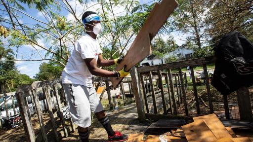 Volunteer cleaning up debris