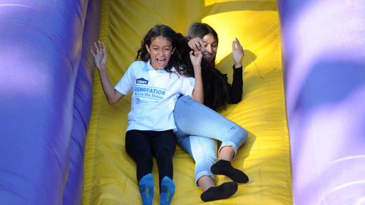Members enjoy an inflatable slide during