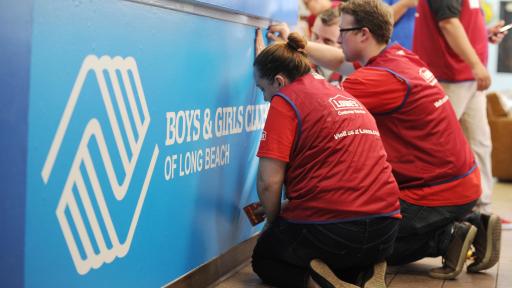 Employee volunteer force, work to spruce up the Fairfield/Westside Boys & Girls Club with new blue paint.