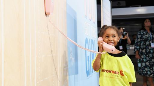 Little girl on a pink phone