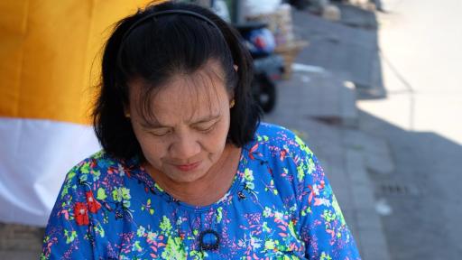 Woman putting a plastic bottle into a plastic bag.