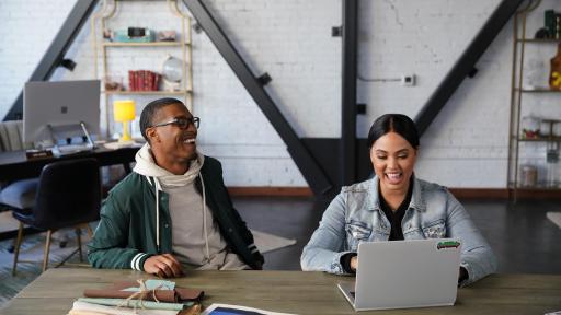 Ayesha Curry using a laptop, sitting by a guy laughing