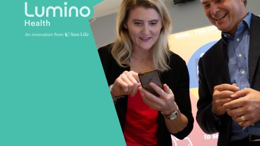 Hayley Wickenheiser and Chris Denys looking at iphone