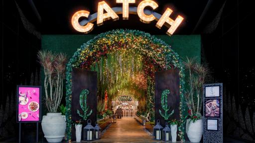 The stunning entrance to the new restaurant Catch. The black doors open to a hall with a trellis leading into the dining room.