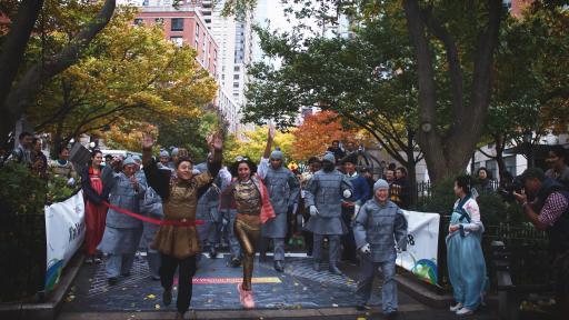 race participants start the race, running through a red ribbon